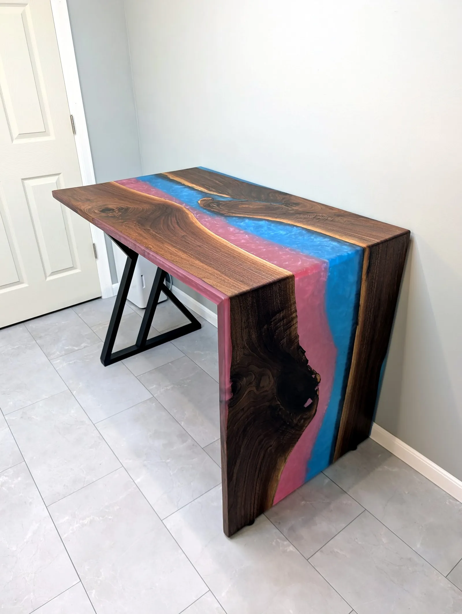 Console table with rose and teal dual-color epoxy waterfall edge