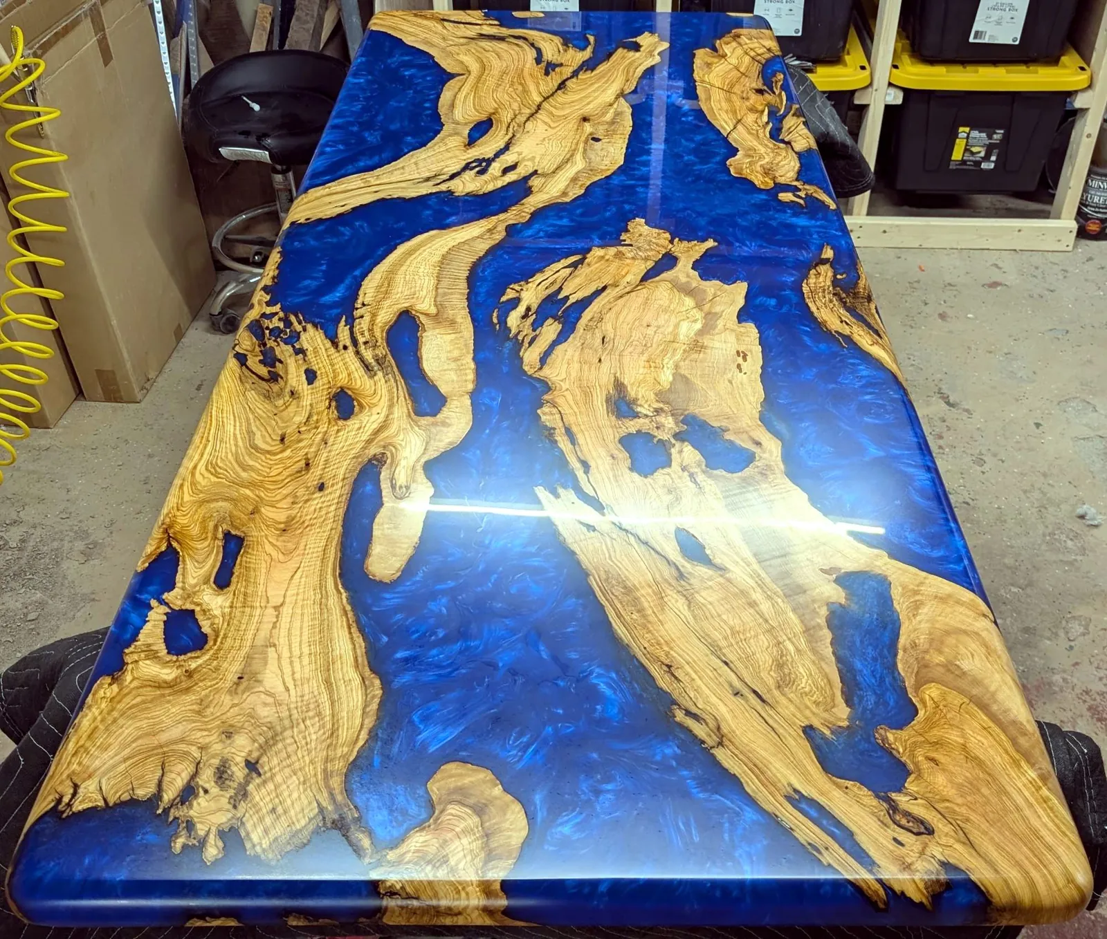 Turkish olive wood tabletop with a deep blue epoxy river
